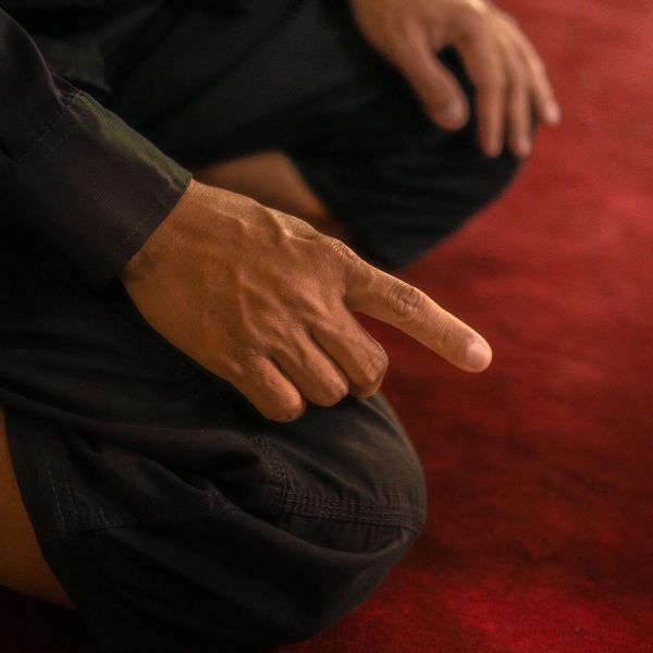 Close-up of hands in a meditative gesture, focusing on mindfulness.